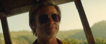 Movie still from “Once Upon a Time in Hollywood” (2019), directed by Quentin Tarantino – A person wearing sunglasses; Close Up shot, Low angle