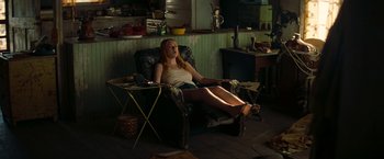 Movie still from “Once Upon a Time in Hollywood” (2019), directed by Quentin Tarantino – A woman sitting in a recliner in a room; Wide shot, High angle