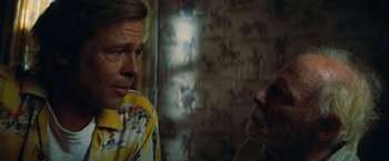 Movie still from “Once Upon a Time in Hollywood” (2019), directed by Quentin Tarantino – Two men are talking in a room with horses on the wall; Close Up shot, Over the shoulder angle
