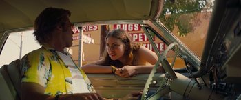 Movie still from “Once Upon a Time in Hollywood” (2019), directed by Quentin Tarantino – A woman sitting in the back of a car; Medium shot, Over the shoulder angle