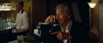 Movie still from “Once Upon a Time in Hollywood” (2019), directed by Quentin Tarantino – An older man talking on a phone while sitting at a table; Close Up shot, Over the shoulder angle