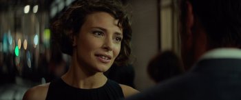 Movie still from “The Gunman” (2015), directed by Pierre Morel – A person wearing a black dress; Close Up shot, Over the shoulder angle