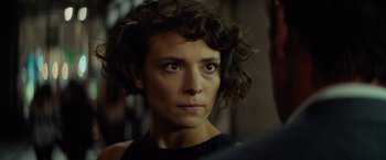 Movie still from “The Gunman” (2015), directed by Pierre Morel – A person wearing a black shirt; Close Up shot, Over the shoulder angle