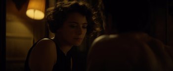 Movie still from “The Gunman” (2015), directed by Pierre Morel – A person looking at a mirror; Close Up shot, Over the shoulder angle