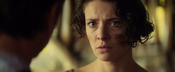 Movie still from “The Gunman” (2015), directed by Pierre Morel – A person looking at the camera; Close Up shot, Over the shoulder angle