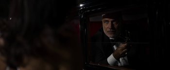 Movie still from “The Hand of God” (2021), directed by Paolo Sorrentino – A man wearing a suit and tie looking out a window; Close Up shot, Low angle