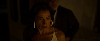 Movie still from “The Hand of God” (2021), directed by Paolo Sorrentino – A person wearing a white shirt and earrings; Close Up shot, Low angle