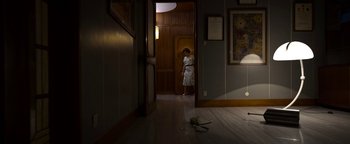 Movie still from “The Hand of God” (2021), directed by Paolo Sorrentino – A woman standing in a room with a pair of scissors; Wide shot, High angle