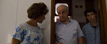 Movie still from “The Hand of God” (2021), directed by Paolo Sorrentino – An older man and a younger woman looking at each other; Medium shot, Over the shoulder angle