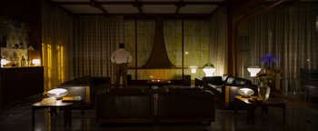 Movie still from “The Hand of God” (2021), directed by Paolo Sorrentino – A man standing in front of a window in a living room; Wide shot, Low angle