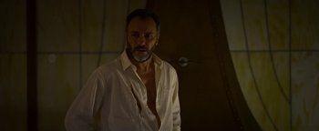 Movie still from “The Hand of God” (2021), directed by Paolo Sorrentino – A man in a white shirt is looking at the camera; Close Up shot, Low angle