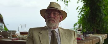 Movie still from “The Hand of God” (2021), directed by Paolo Sorrentino – An older man wearing a suit and a hat; Close Up shot, Low angle