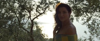 Movie still from “The Hand of God” (2021), directed by Paolo Sorrentino – A woman standing next to a tree in the sunlight; Close Up shot, Low angle