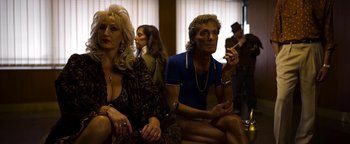 Movie still from “The Hand of God” (2021), directed by Paolo Sorrentino – A man and a woman sitting next to each other in a room; Medium shot, Low angle