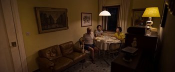 Movie still from “The Hand of God” (2021), directed by Paolo Sorrentino – A group of people sitting around a table eating food; Wide shot, High angle