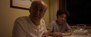 Movie still from “The Hand of God” (2021), directed by Paolo Sorrentino – An older man sitting next to a younger man; Close Up shot, Over the shoulder angle