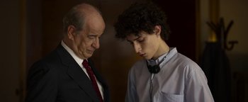 Movie still from “The Hand of God” (2021), directed by Paolo Sorrentino – An older man and a young man are looking at each other; Close Up shot, Over the shoulder angle