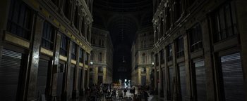 Movie still from “The Hand of God” (2021), directed by Paolo Sorrentino – People are gathered in an indoor area of a building; Extreme Wide shot, High angle