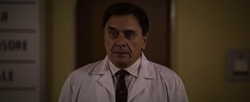 Movie still from “The Hand of God” (2021), directed by Paolo Sorrentino – A person wearing a lab coat; Close Up shot, Low angle