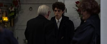 Movie still from “The Hand of God” (2021), directed by Paolo Sorrentino – A man in a black jacket talking to another man in a white shirt; Medium shot, Over the shoulder angle