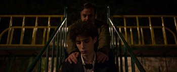 Movie still from “The Hand of God” (2021), directed by Paolo Sorrentino – A man sitting on the shoulders of a young man; Medium shot, Over the shoulder angle