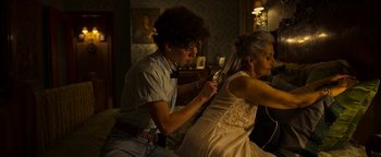 Movie still from “The Hand of God” (2021), directed by Paolo Sorrentino – A man is helping a woman with her wedding dress; Medium shot, Over the shoulder angle