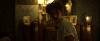 Movie still from “The Hand of God” (2021), directed by Paolo Sorrentino – A young man in a white dress shirt and tie; Close Up shot, Over the shoulder angle