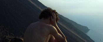 Movie still from “The Hand of God” (2021), directed by Paolo Sorrentino – A man sitting on the ground with his head in his hands; Close Up shot, High angle