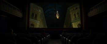 Movie still from “The Hand of God” (2021), directed by Paolo Sorrentino – Two people are sitting in a movie theater at night; Extreme Wide shot, Low angle