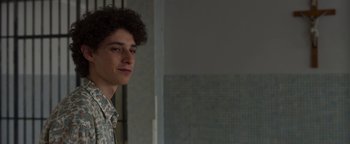 Movie still from “The Hand of God” (2021), directed by Paolo Sorrentino – A young man is looking into the distance; Close Up shot, Over the shoulder angle