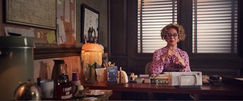 Movie still from “The Happytime Murders” (2018), directed by Brian Henson – A woman sitting at a table with a cup of coffee; Medium shot, Over the shoulder angle