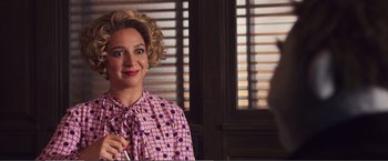 Movie still from “The Happytime Murders” (2018), directed by Brian Henson – A woman in a pink polka dot shirt holding a toothbrush; Close Up shot, Over the shoulder angle