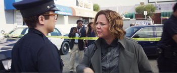 Movie still from “The Happytime Murders” (2018), directed by Brian Henson – A woman is talking to a police officer on the street; Medium shot, Over the shoulder angle