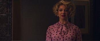 Movie still from “The Happytime Murders” (2018), directed by Brian Henson – A woman with blonde curly hair wearing a pink and black polka dot shirt; Close Up shot, Low angle