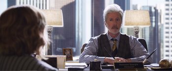 Movie still from “The Happytime Murders” (2018), directed by Brian Henson – A man sitting at a desk in front of a window; Medium shot, Over the shoulder angle