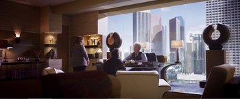 Movie still from “The Happytime Murders” (2018), directed by Brian Henson – A group of people sitting at a table in front of a window; Wide shot, Over the shoulder angle