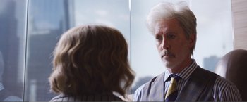 Movie still from “The Happytime Murders” (2018), directed by Brian Henson – A man in a suit and tie looking at a woman in front of a mirror; Close Up shot, Over the shoulder angle