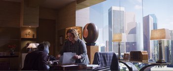 Movie still from “The Happytime Murders” (2018), directed by Brian Henson – A woman sitting at a table in front of a window; Wide shot, Over the shoulder angle