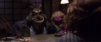 Movie still from “The Happytime Murders” (2018), directed by Brian Henson – Two people sitting at a table with stuffed animals; Medium shot, Over the shoulder angle