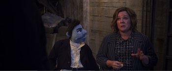 Movie still from “The Happytime Murders” (2018), directed by Brian Henson – A woman standing next to a man in a suit and tie; Medium shot, Over the shoulder angle