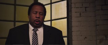 Movie still from “The Happytime Murders” (2018), directed by Brian Henson – A man wearing a suit and tie with his mouth open; Close Up shot, Over the shoulder angle