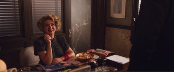 Movie still from “The Happytime Murders” (2018), directed by Brian Henson – A woman sitting at a table in front of a bowl of food; Medium shot, Over the shoulder angle