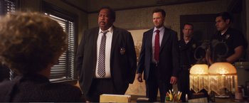 Movie still from “The Happytime Murders” (2018), directed by Brian Henson – Two men standing next to each other in a room; Medium shot, Low angle