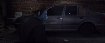 Movie still from “The Happytime Murders” (2018), directed by Brian Henson – A man walking down a street next to a car; Wide shot, Over the shoulder angle