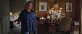 Movie still from “The Happytime Murders” (2018), directed by Brian Henson – A woman standing in front of a wooden wall; Wide shot, Over the shoulder angle