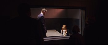 Movie still from “The Happytime Murders” (2018), directed by Brian Henson – A man standing next to a doll on a table; Wide shot, Over the shoulder angle