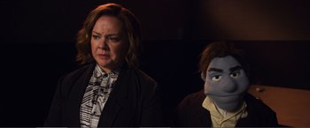 Movie still from “The Happytime Murders” (2018), directed by Brian Henson – A woman standing next to a man wearing a mask; Close Up shot, Over the shoulder angle