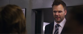 Movie still from “The Happytime Murders” (2018), directed by Brian Henson – A man wearing a suit and tie standing next to a woman; Close Up shot, Over the shoulder angle