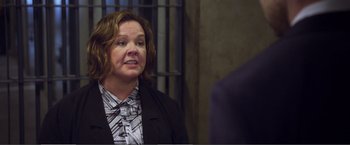 Movie still from “The Happytime Murders” (2018), directed by Brian Henson – A woman wearing a suit and tie talking to a man in a suit and tie; Close Up shot, Over the shoulder angle