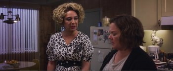 Movie still from “The Happytime Murders” (2018), directed by Brian Henson – Two women standing next to each other in front of a refrigerator; Medium shot, Over the shoulder angle